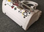 Vibrant Embossed Cartoon Leather Arm Bag