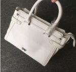 Vibrant Embossed Cartoon Leather Arm Bag