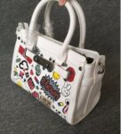 Vibrant Embossed Cartoon Leather Arm Bag