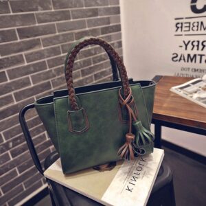brown woven handled tasseled dark green bag