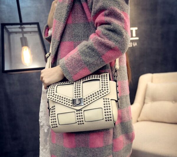 cream color studded rivet leather sleeve bag