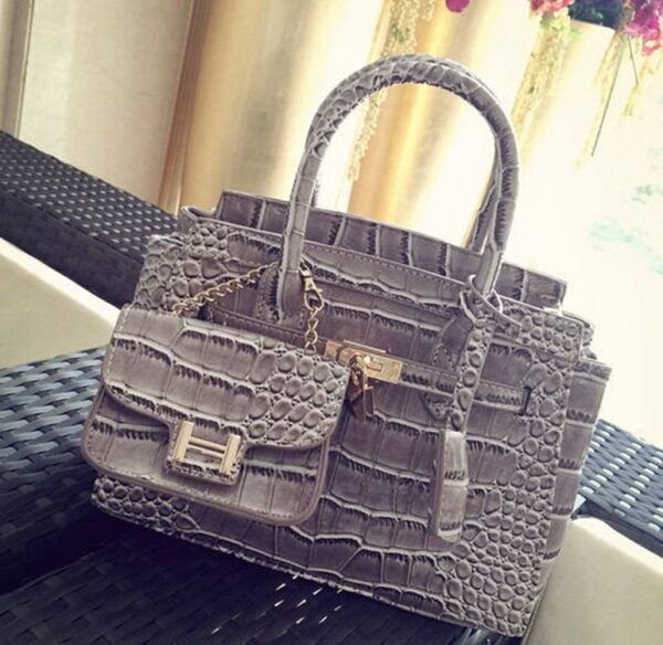 crocodile patterned gray patent sleeve bag
