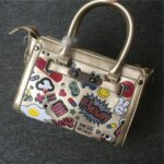 Vibrant Embossed Cartoon Leather Arm Bag