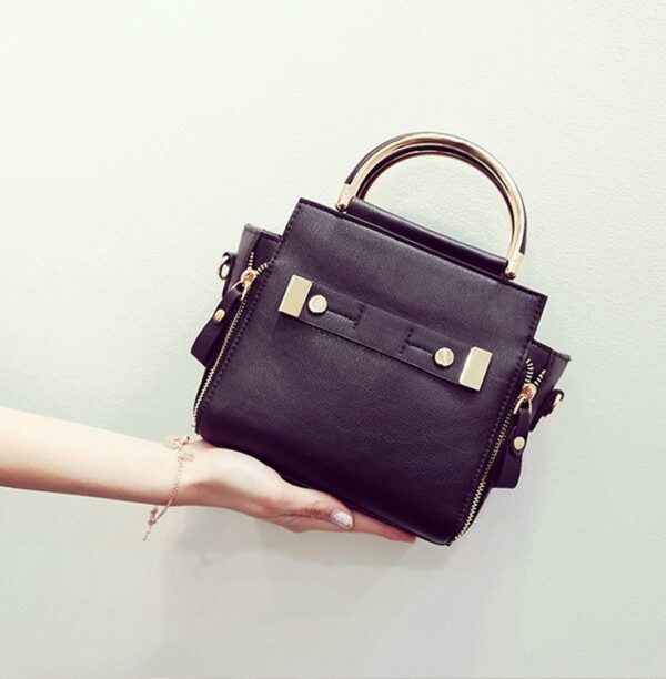 gold handled black shoulder bag